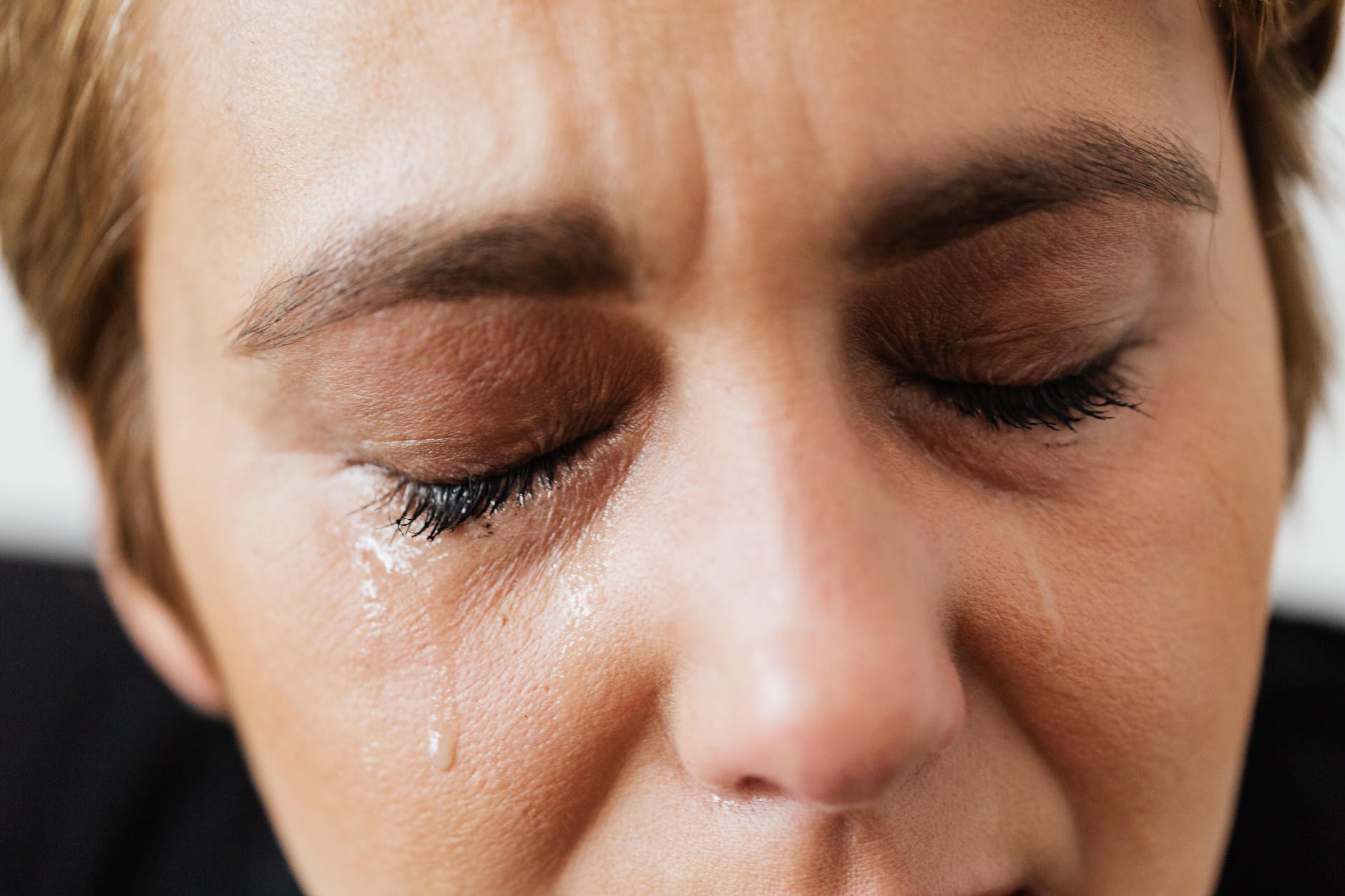 tears on face of crop anonymous woman